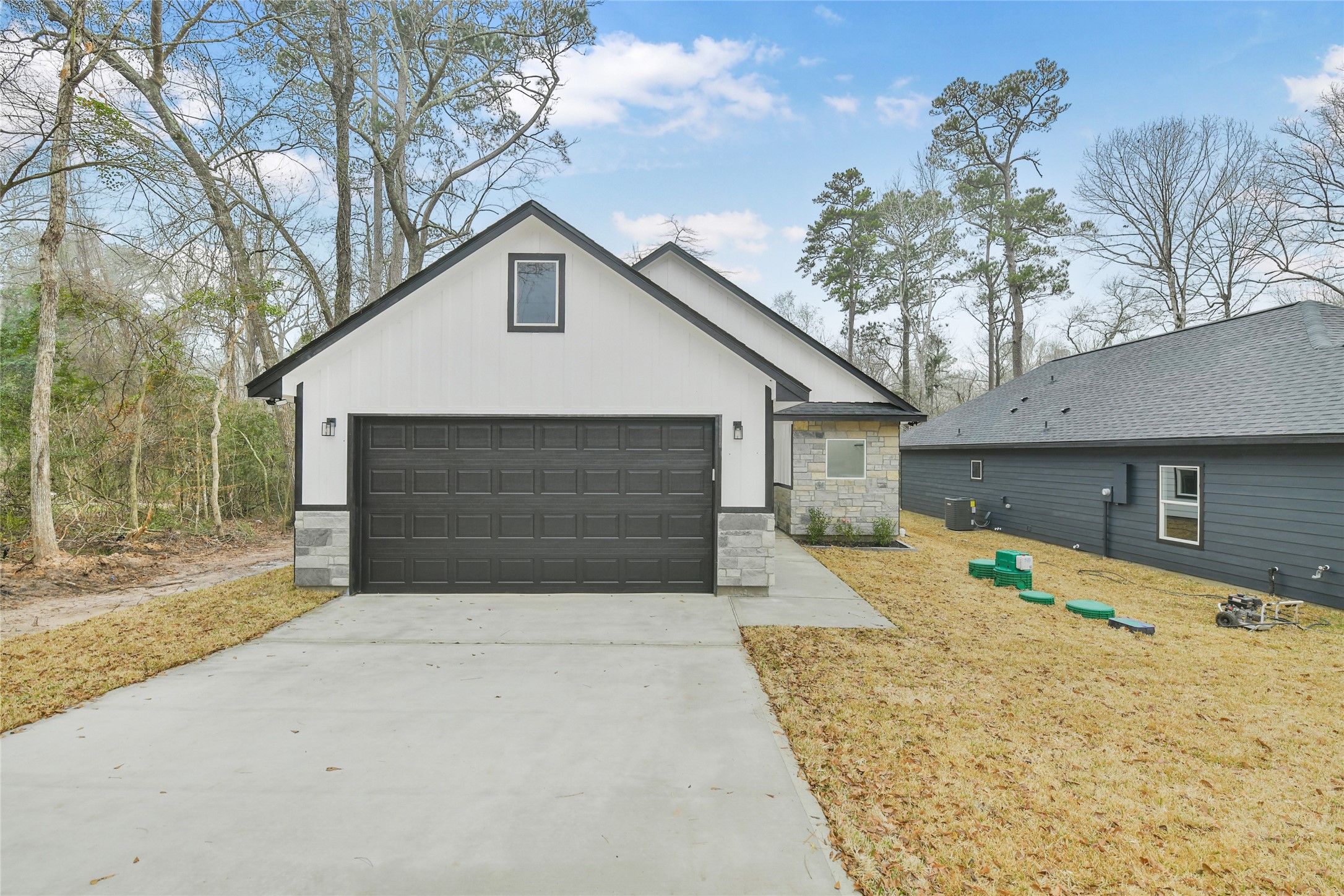 15113 Austin Road Willis, TX 77378 - Photo 36 of 37 a front view of a house with a yard and garage