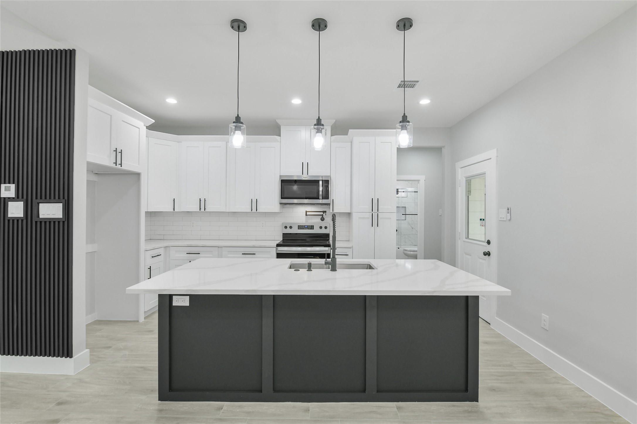 15113 Austin Road Willis, TX 77378 - Photo 9 of 37 a large kitchen with kitchen island a sink stainless steel appliances and cabinets