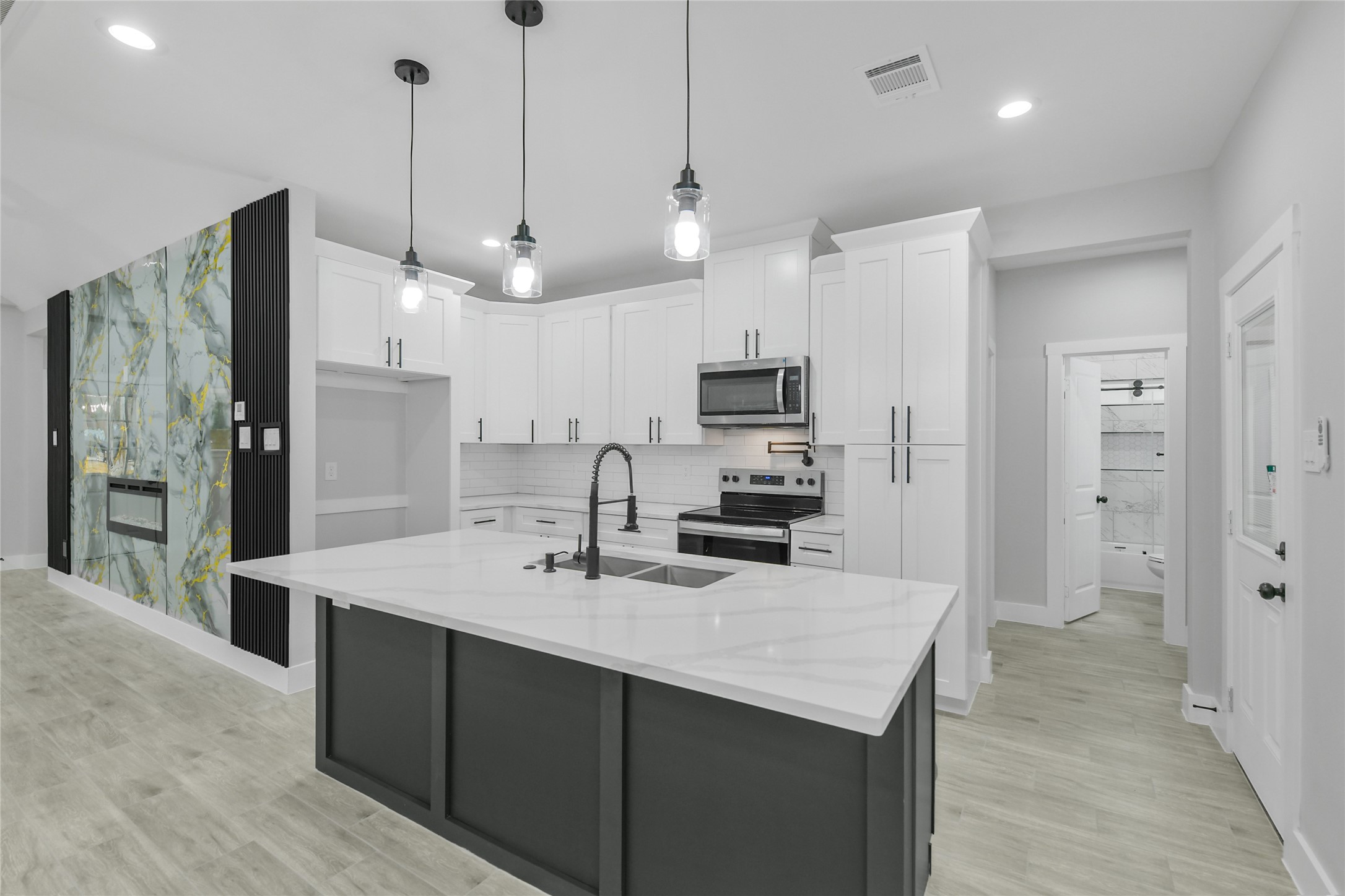 15113 Austin Road Willis, TX 77378 - Photo 10 of 37 a kitchen with kitchen island a sink stainless steel appliances and refrigerator