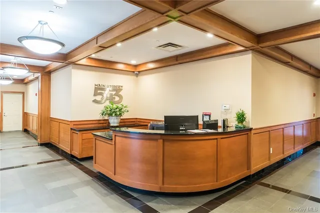 a kitchen with stainless steel appliances granite countertop a sink a stove and a wooden floors