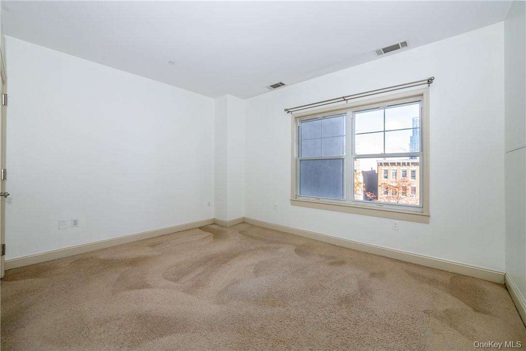 543 Main Street, Unit 410 New Rochelle, NY 10801 - Photo 11 of 24 an empty room with a window