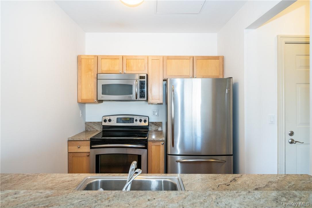 543 Main Street, Unit 410 New Rochelle, NY 10801 - Photo 4 of 24 a kitchen with a stove and a microwave