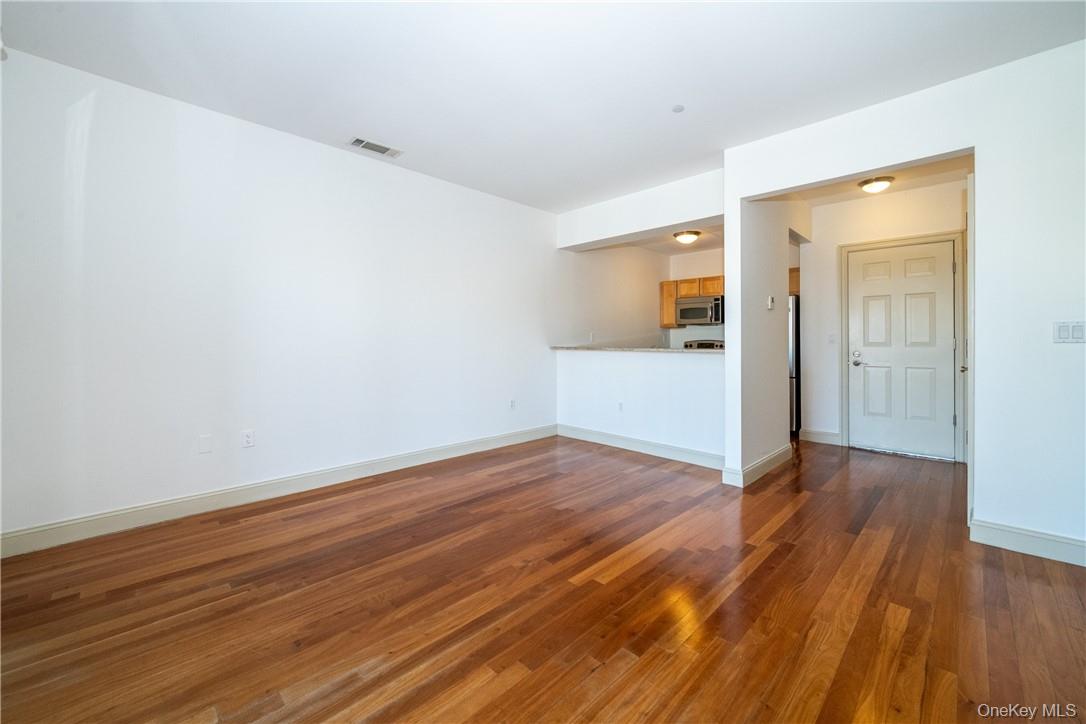 543 Main Street, Unit 410 New Rochelle, NY 10801 - Photo 7 of 24 a view of a room with wooden floor