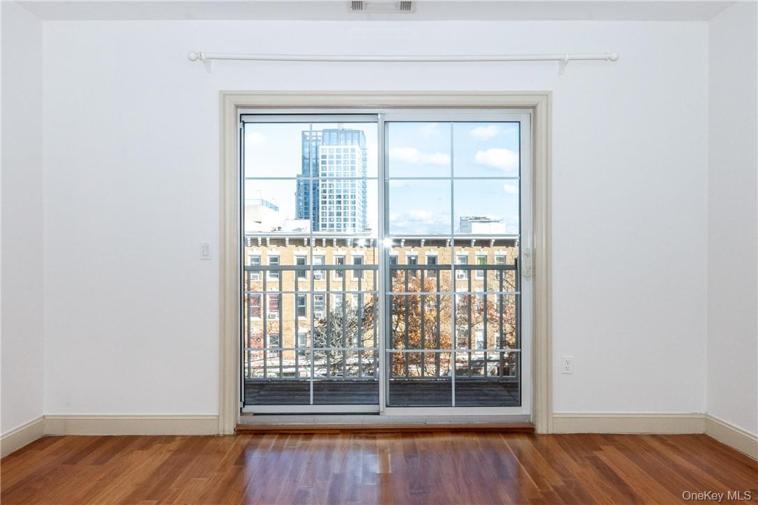 543 Main Street, Unit 410 New Rochelle, NY 10801 - Photo 9 of 24 a view of wooden floor and brick walls