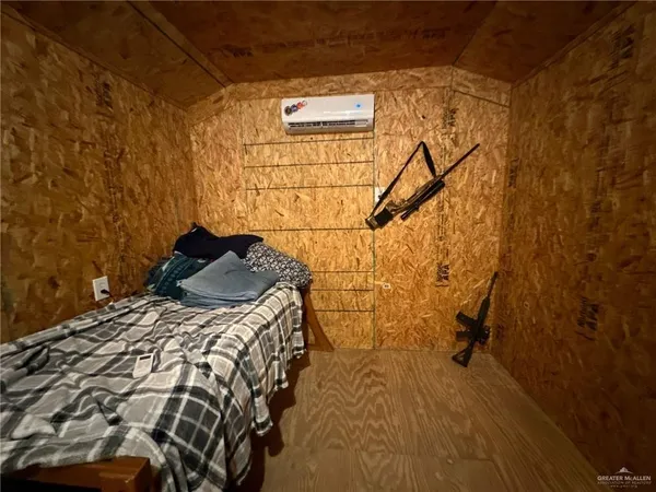 a bed sitting in a bedroom next to a bathroom