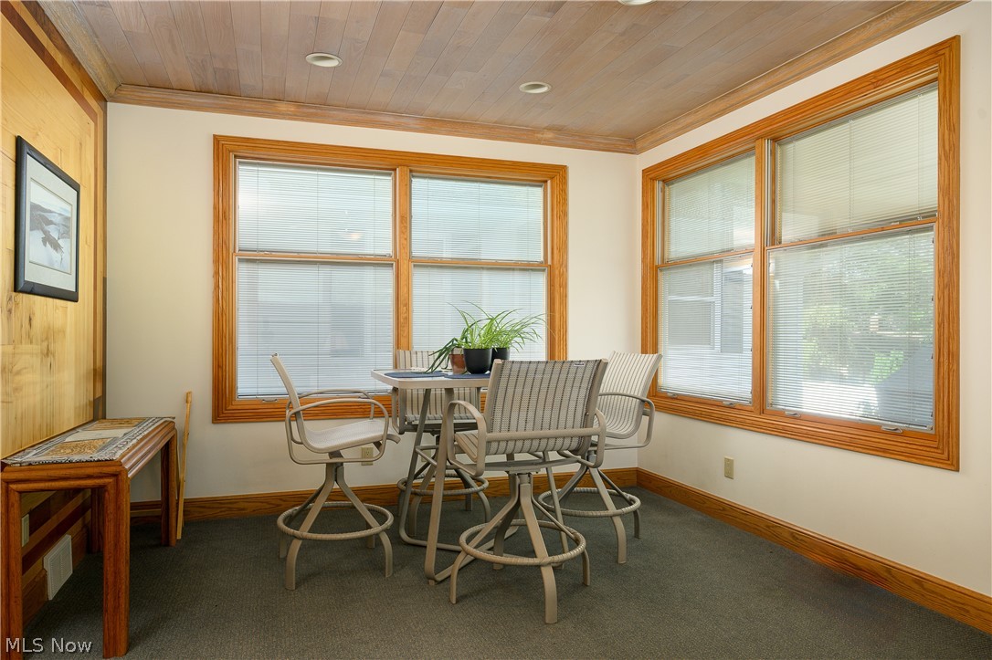 2371 Sunnybrook Road Mogadore, OH 44260 - Photo 15 of 26 Carpeted dining space with a healthy amount of sunlight, crown molding, and wooden ceiling