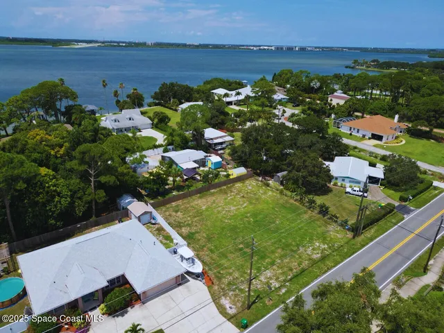 an aerial view of lake houses with outdoor seating