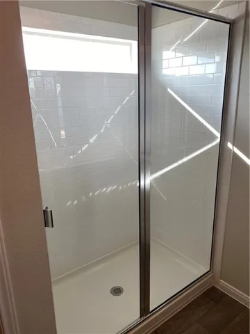 a bathroom with a glass shower door