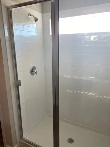 a bathroom with a glass shower door