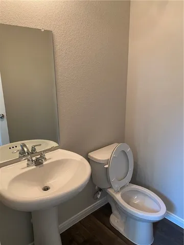 a bathroom with a sink mirror and toilet