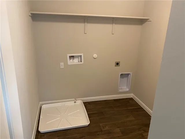 an empty room with wooden floor and cabinet