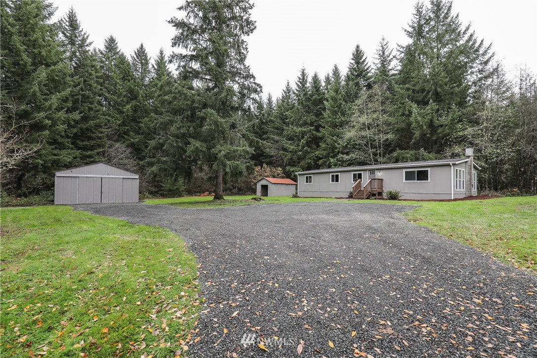 176 Palmer Road Napavine, WA 98532 - Photo 1 of 16 a front view of a house with a yard and trees