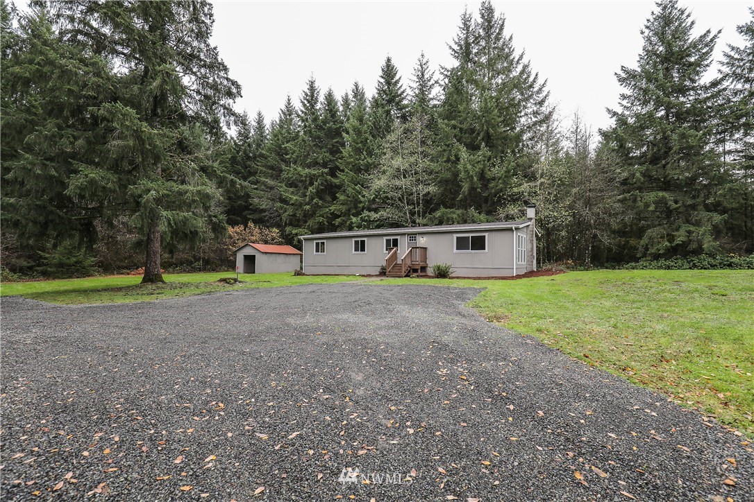 176 Palmer Road Napavine, WA 98532 - Photo 2 of 16 a front view of a house with a yard and garage