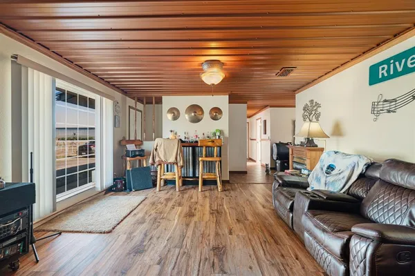 a living room with furniture and wooden floors
