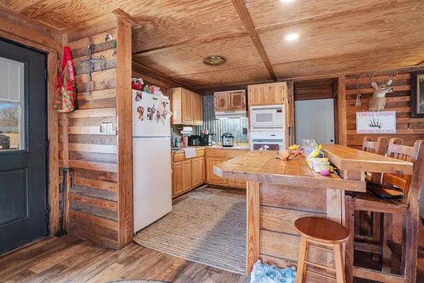 a kitchen with granite countertop a refrigerator and a stove top oven