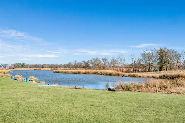a view of a lake with houses in the back