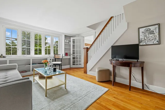 a living room with furniture and a window with wooden floor