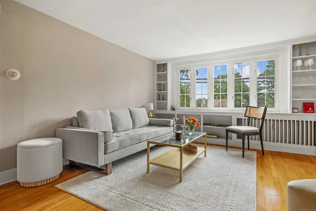 a view of a livingroom with wooden floor and a fireplace