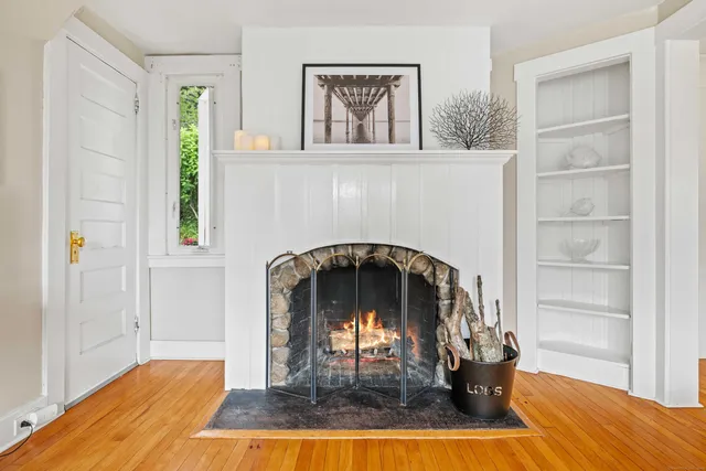 a living room with furniture and a table with wooden floor