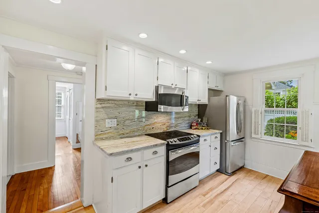 a kitchen with a stove a sink and a refrigerator