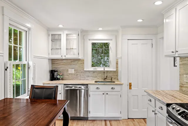 a kitchen with stainless steel appliances a refrigerator stove and sink