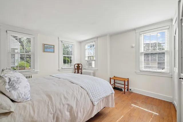 a bedroom with a bed and a chair