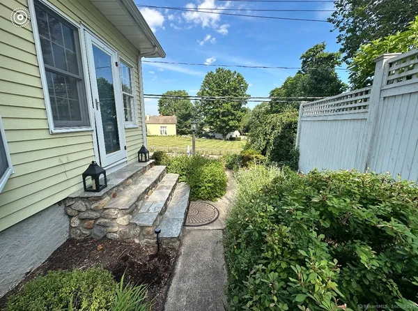 a backyard of a house with table and chairs