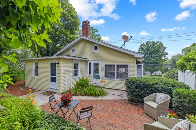 a view of a chairs and table in a backyard