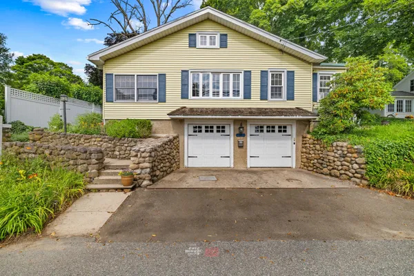 a front view of a house with a garden