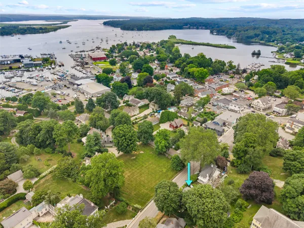 an aerial view of residential houses with outdoor space and lake view