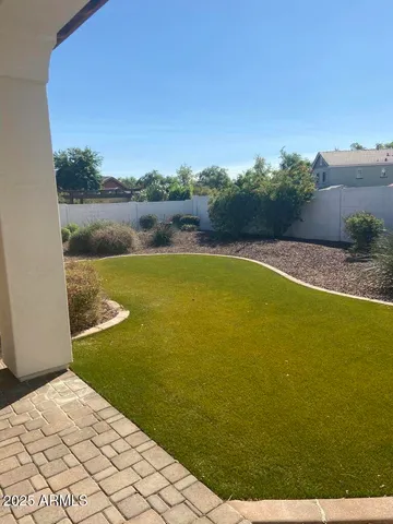 a view of a green field with wooden fence