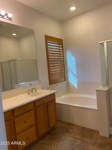 a bathroom with a granite countertop toilet and a sink