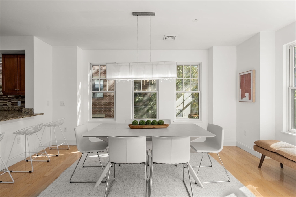 125 Crowninshield Road, Unit 125 Brookline, MA 02446 - Photo 10 of 21 a dining room with furniture and window