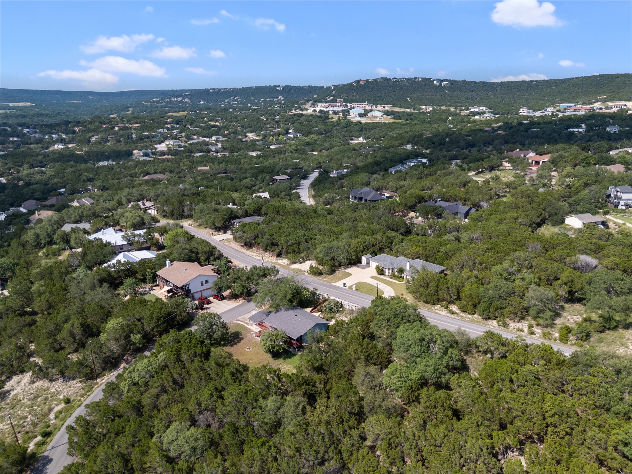21105 Ridgeview Road Lago Vista, TX 78645 - Photo 14 of 34 Nestled in a verdant landscape, this property offers serene, tree-filled views and a peaceful setting.