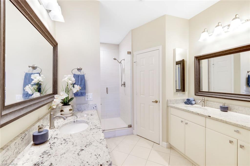 3048 Horizon Lane, Unit 1108 Naples, FL 34109 - Photo 12 of 23 a bathroom with a sink a toilet and shower