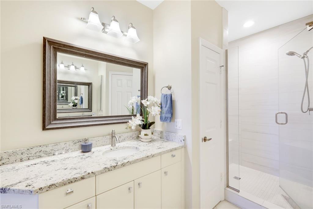 3048 Horizon Lane, Unit 1108 Naples, FL 34109 - Photo 13 of 23 a bathroom with a granite countertop sink mirror and double