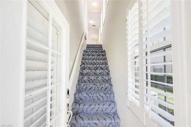 a view of a living room and a floor to ceiling window and an outdoor seating
