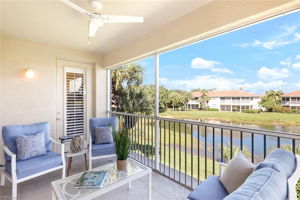 3048 Horizon Lane, Unit 1108 Naples, FL 34109 - Photo 20 of 23 a view of a living room and a floor to ceiling window and an outdoor seating