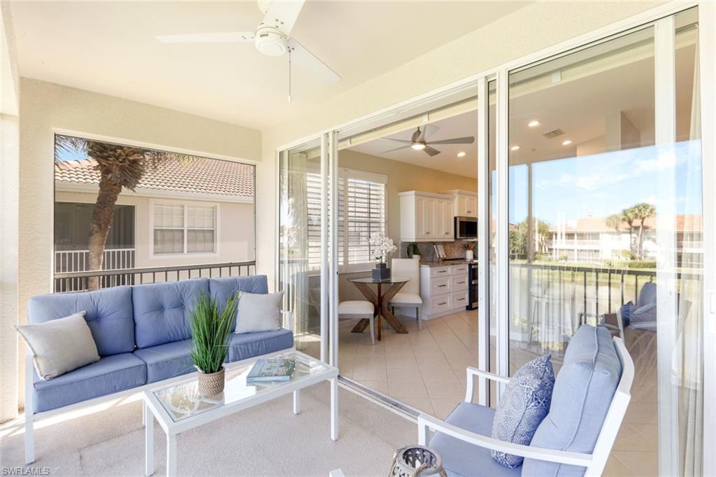 3048 Horizon Lane, Unit 1108 Naples, FL 34109 - Photo 21 of 23 a living room with furniture and a large window with outer view