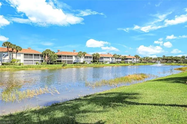 a view of a lake with houses in the back