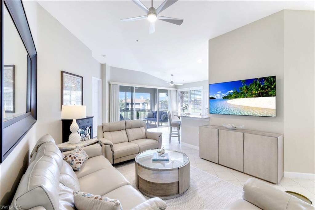 3048 Horizon Lane, Unit 1108 Naples, FL 34109 - Photo 5 of 23 a living room with furniture and a flat screen tv