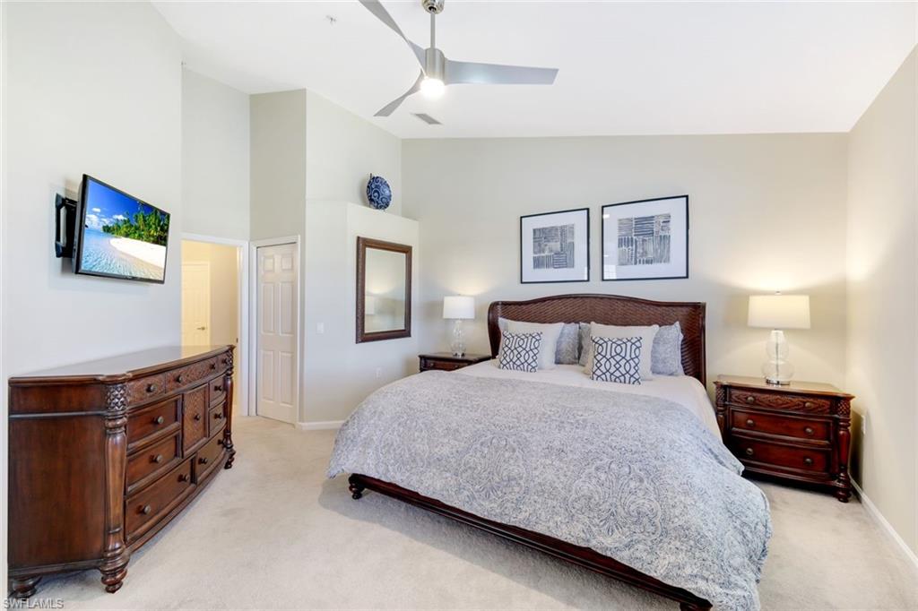 3048 Horizon Lane, Unit 1108 Naples, FL 34109 - Photo 10 of 23 a bedroom with a bed and a night stand