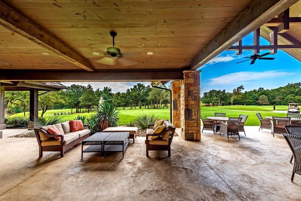113 Shadow Crk Road Gordonville, TX 76245 - Photo 19 of 35 a view of a patio with a dining table and chairs next to a yard