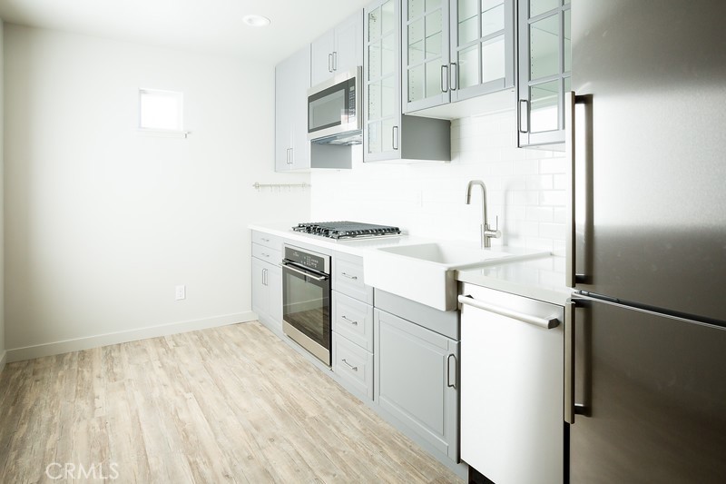 210 Laurel Street, Unit A Avila Beach, CA 93424 - Photo 5 of 16 a kitchen with a stove a refrigerator and a sink