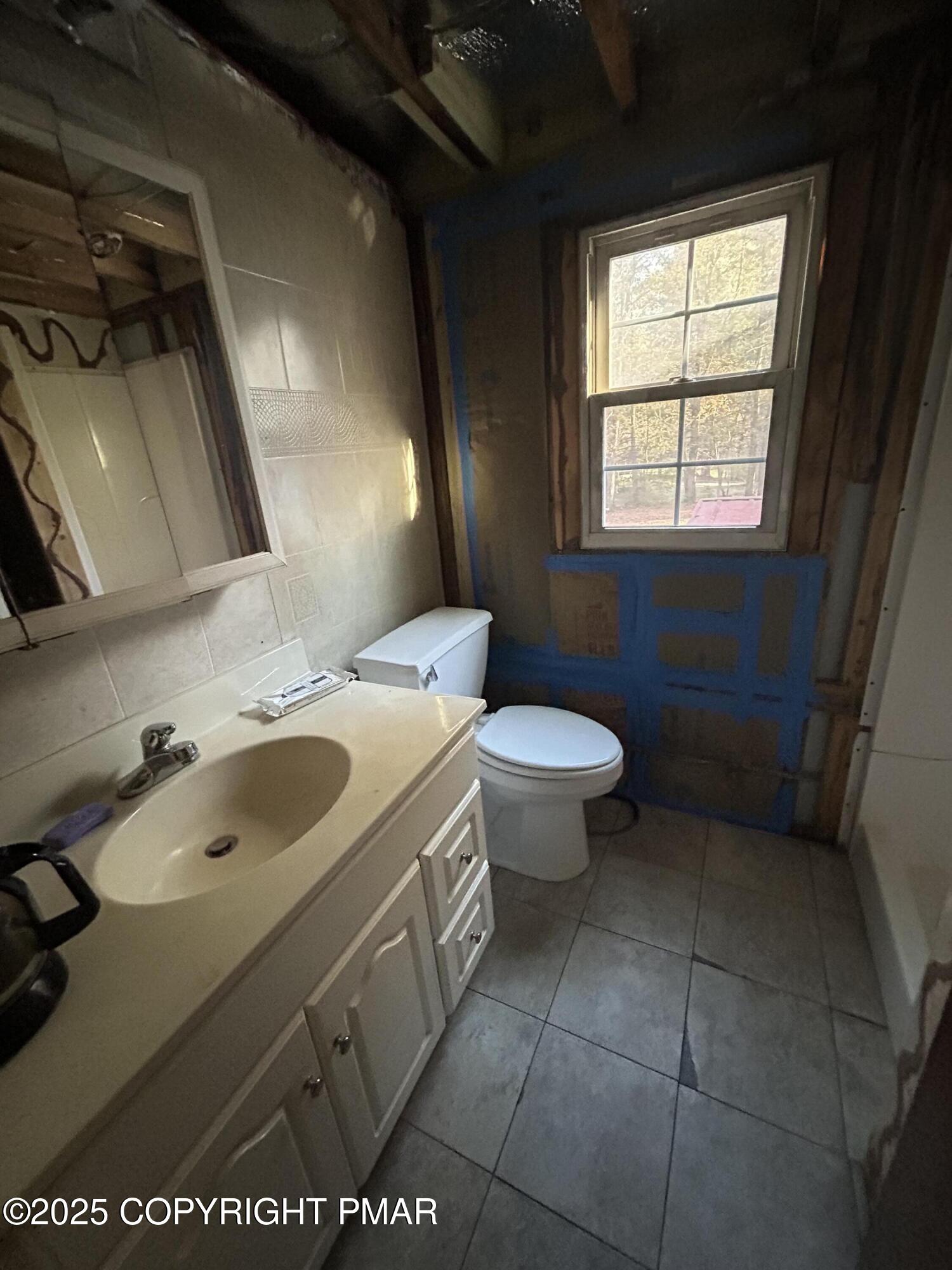 1280 Old Coach Drive Blakeslee, PA 18610 - Photo 3 of 5 a bathroom with a sink toilet and window