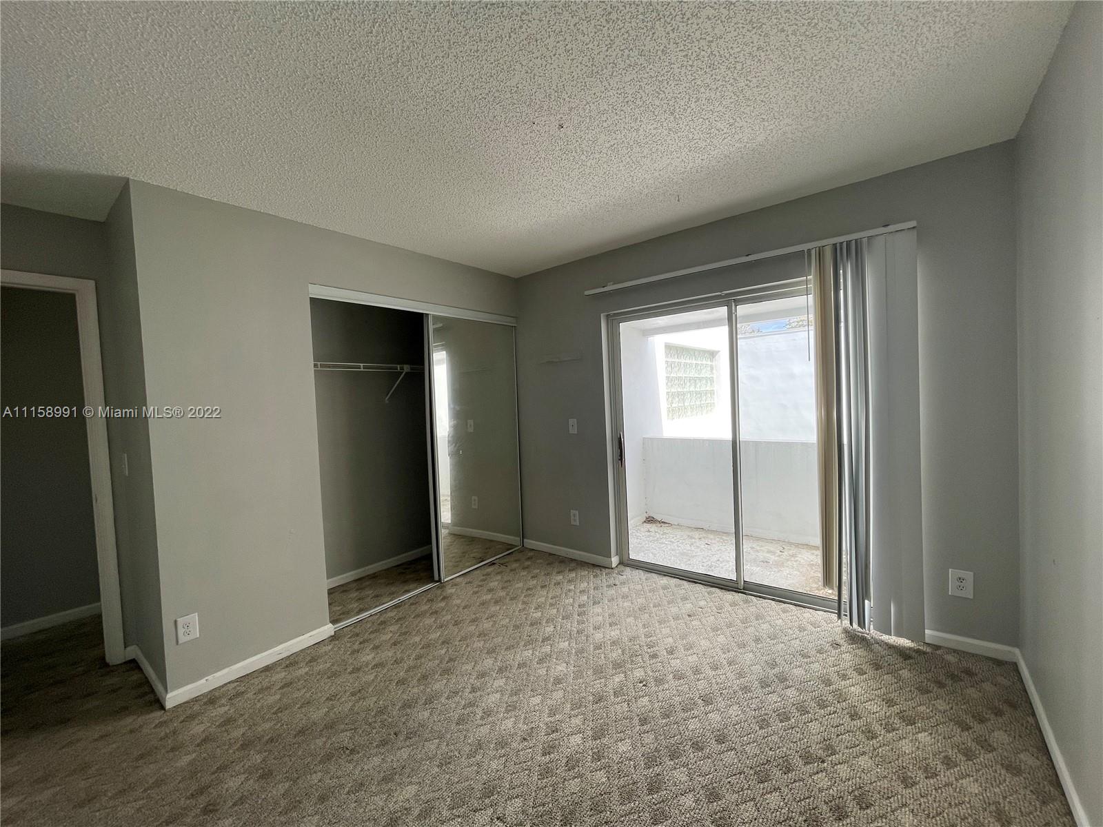 5140 Elmhurst Road, Unit H West Palm Beach, FL 33417 - Photo 11 of 15 an empty room with closet area