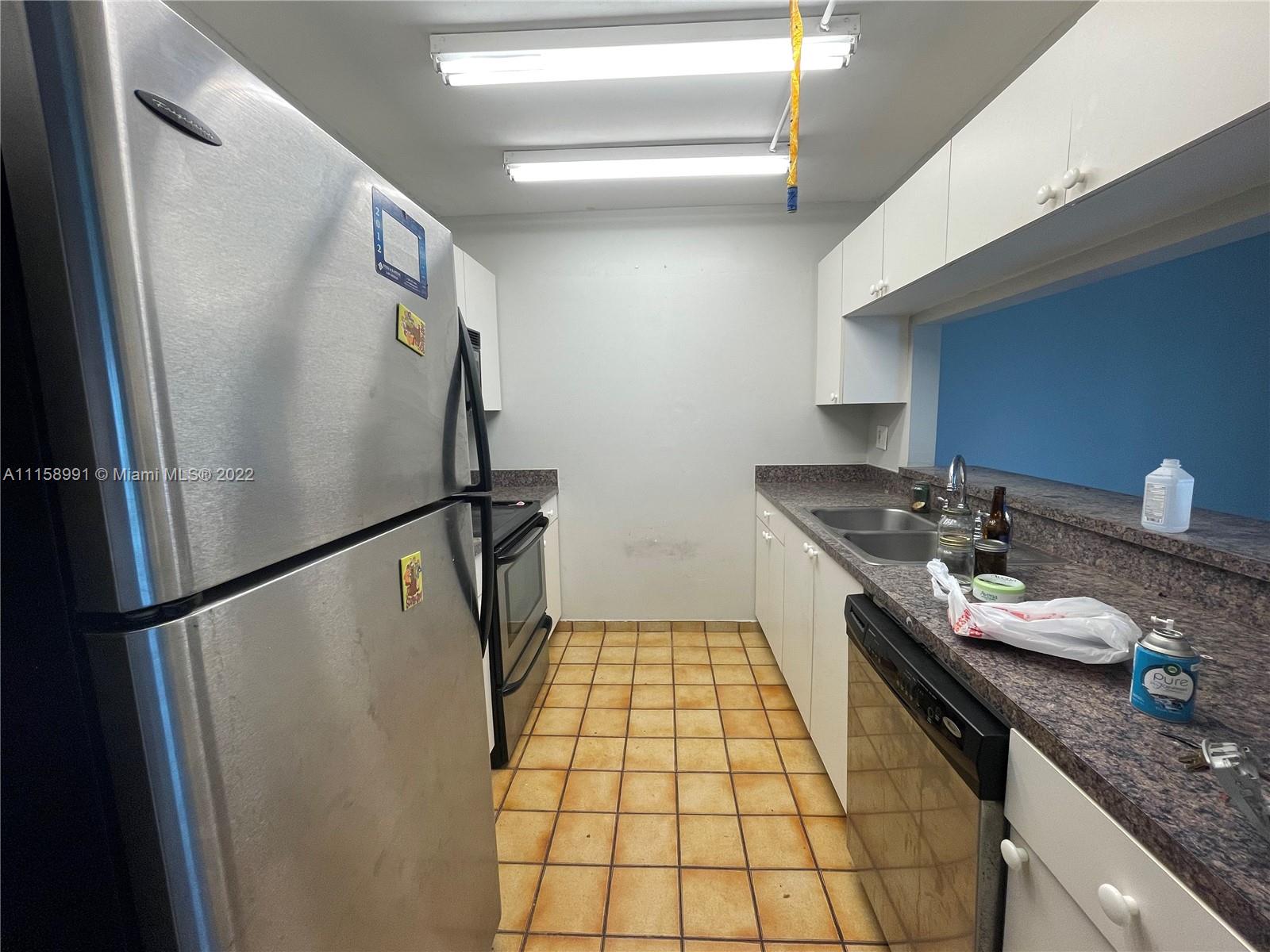 5140 Elmhurst Road, Unit H West Palm Beach, FL 33417 - Photo 3 of 15 a bathroom with a granite countertop sink toilet and shower