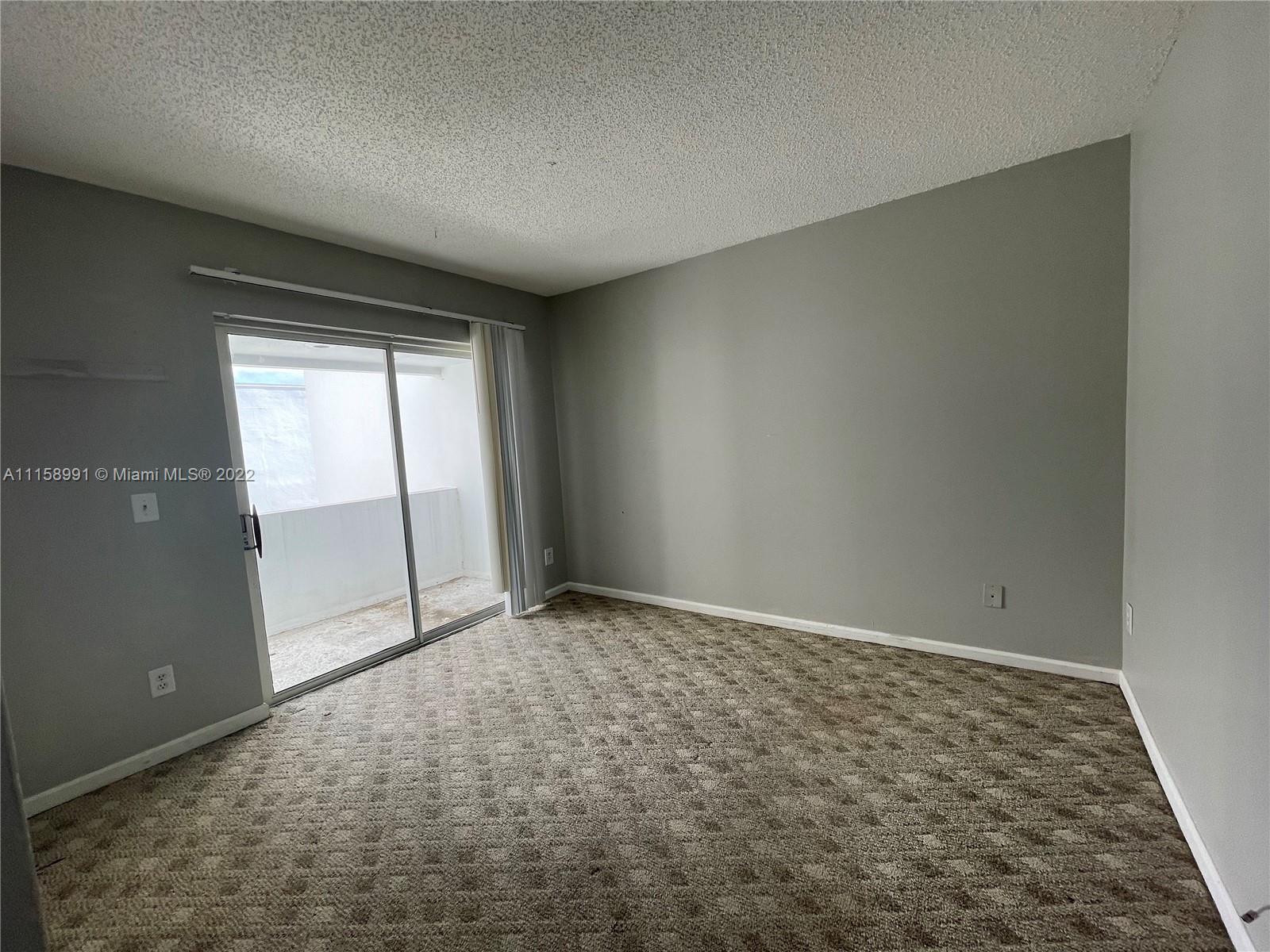 5140 Elmhurst Road, Unit H West Palm Beach, FL 33417 - Photo 10 of 15 an empty room with windows