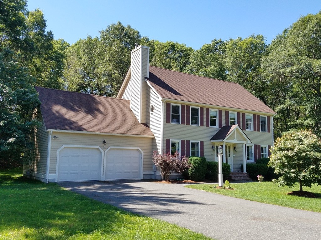 a view of a house with a yard plants and a small yard