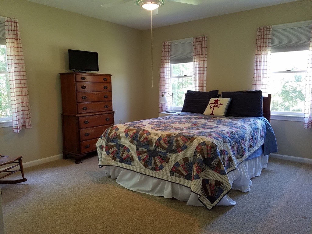 16 Cadorette Road Ashland, MA 01721 - Photo 23 of 29 a bedroom with a bed and a flat tv screen